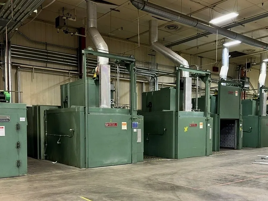 Row of Lindberg industrial ovens being decommissioned in a plant